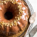 Overhead shot of a zucchini bundt cake with a knife and cake spatula.