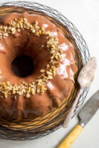 Overhead shot of a zucchini bundt cake with a knife and cake spatula.