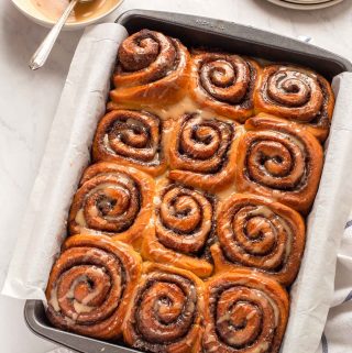 Baking pan with twelve glazed cinnamon rolls