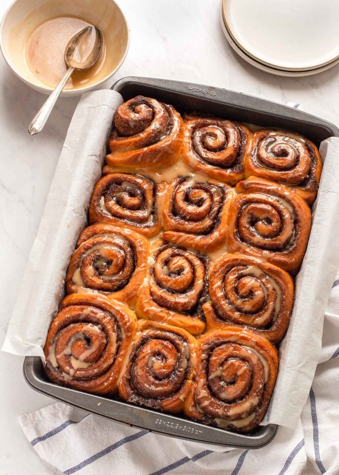 Baking pan with twelve glazed cinnamon rolls