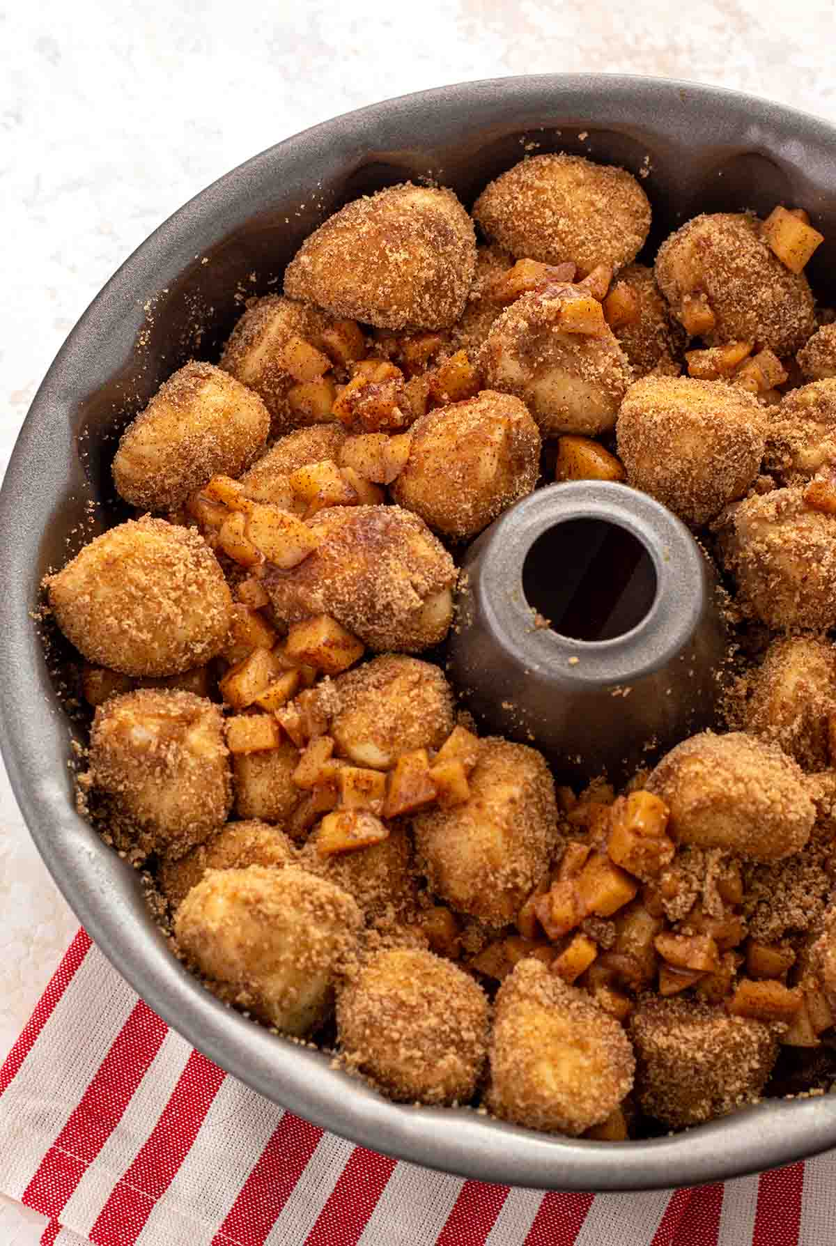 Bundt pan filled with cinnamon sugar coated dinner rolls and fried apples.
