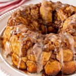 Apple Fritter Monkey Bread close up shot topped with vanilla bean glaze.