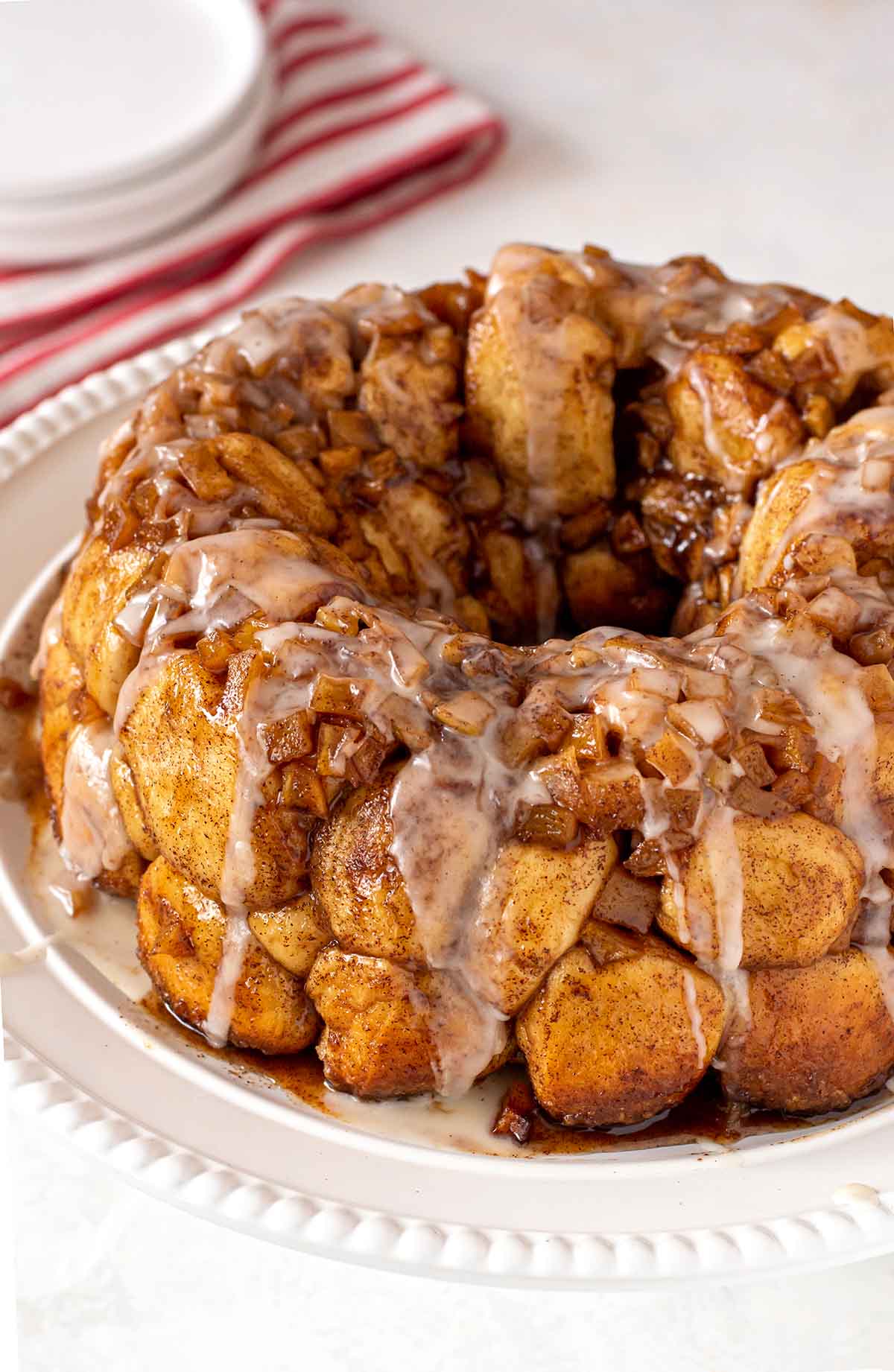 Apple Fritter Monkey Bread close up shot topped with vanilla bean glaze.