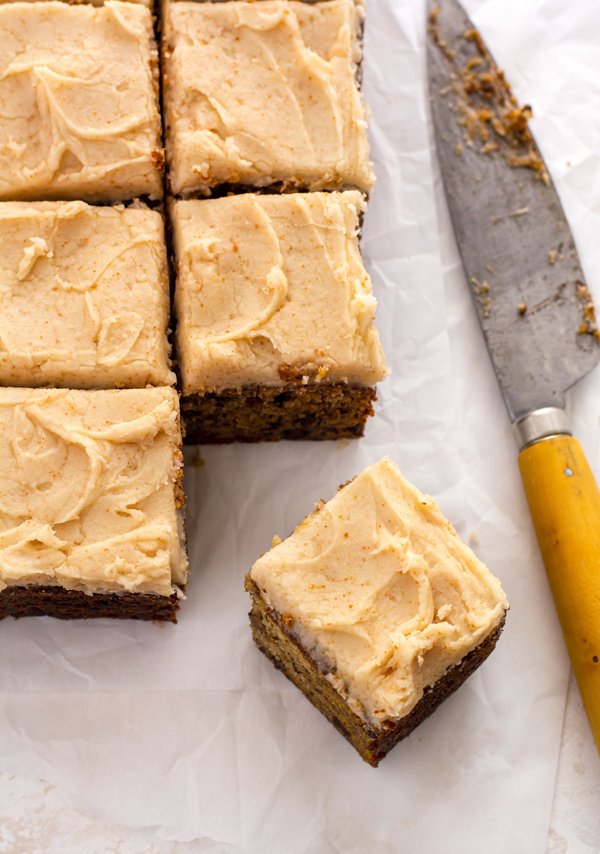 Banana cake cut into squares. One corner piece pulled out slightly.